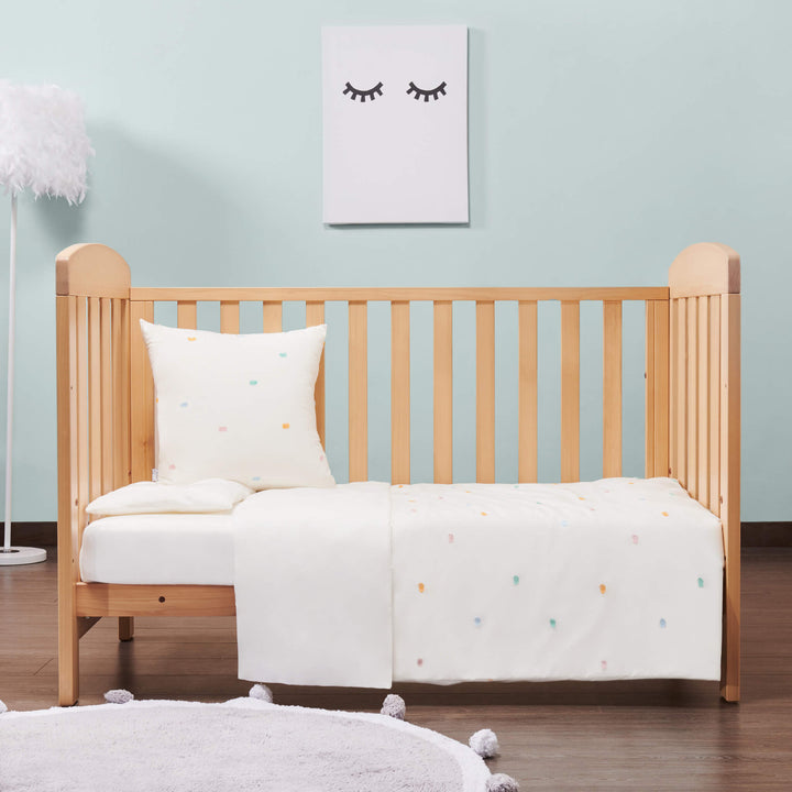 Almond colored Alice Cot Bed with one side rail down