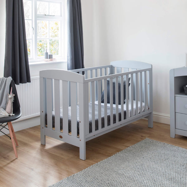 Pebble colored Alice Cot bed placed near a window