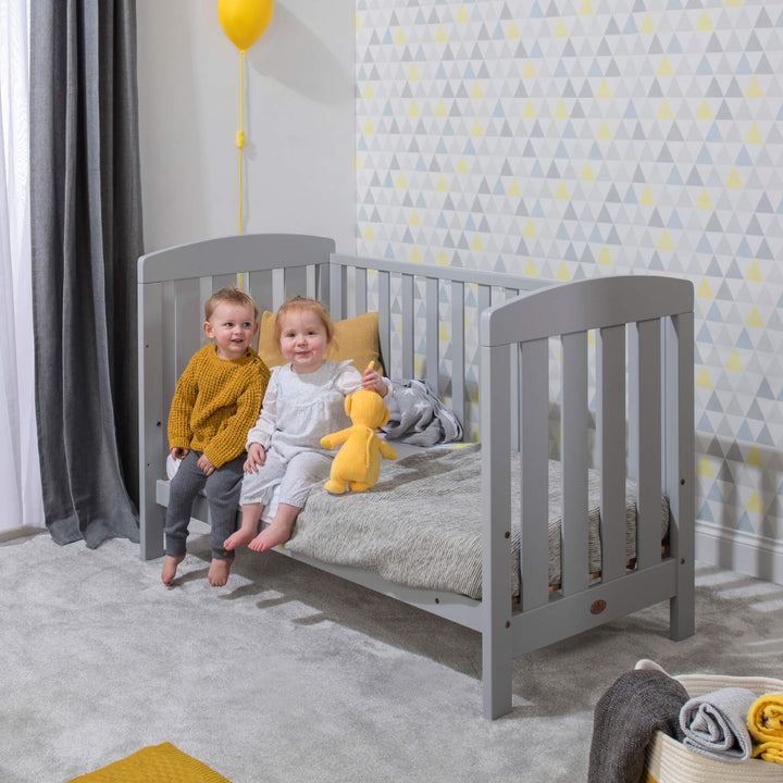 kids sitting on the Pebble colored Alice Cot bed