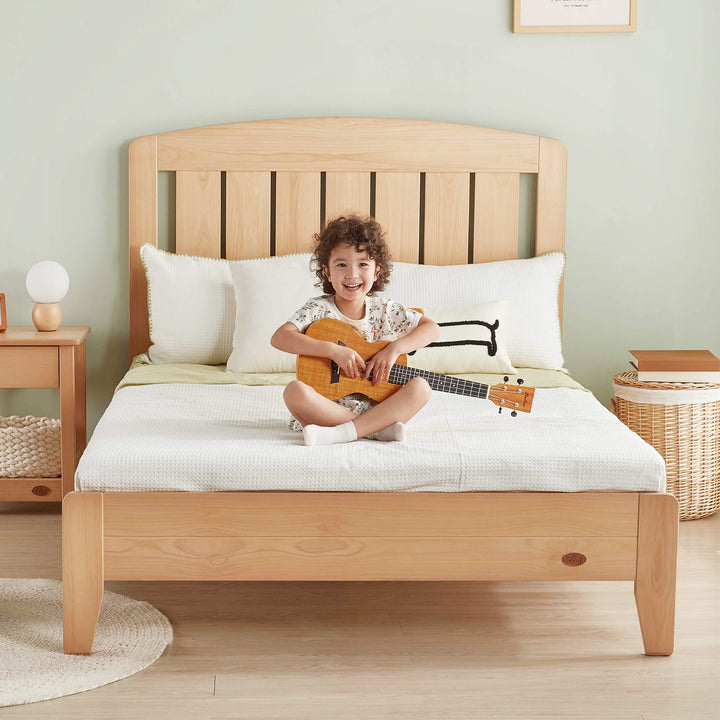 Kid with guitar sitting on the Alice Double Bed