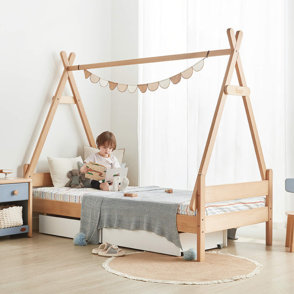 Kid reading and sitting on the Forest Teepee Single Bed with Canopy