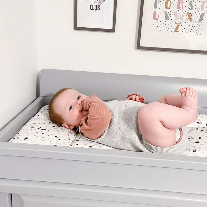 Baby lying down on Sleigh Changing Station