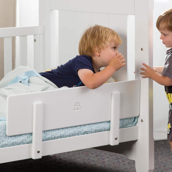 Toddler in bed with guard panel