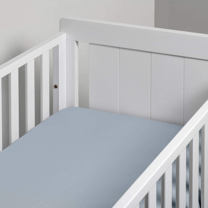 blue fitted sheet in cot bed