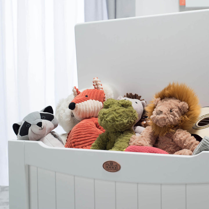 close up of toy box with soft toys