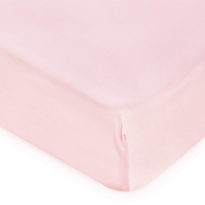 corner of pink cot bed fitted sheet
