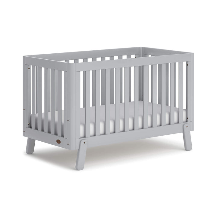 grey cot bed with spindles, rounded corners and feet